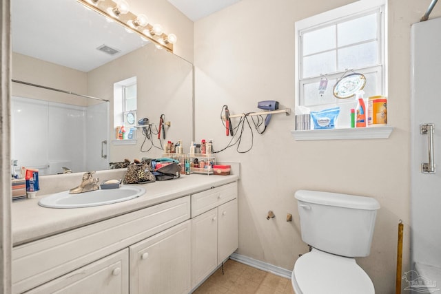 bathroom with a shower, vanity, and toilet