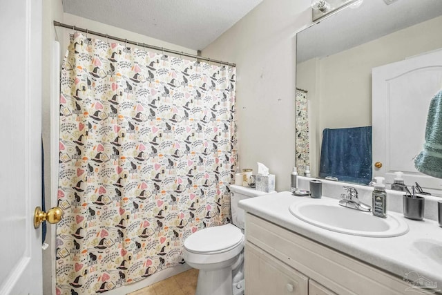 bathroom featuring vanity, tile patterned floors, a textured ceiling, and toilet