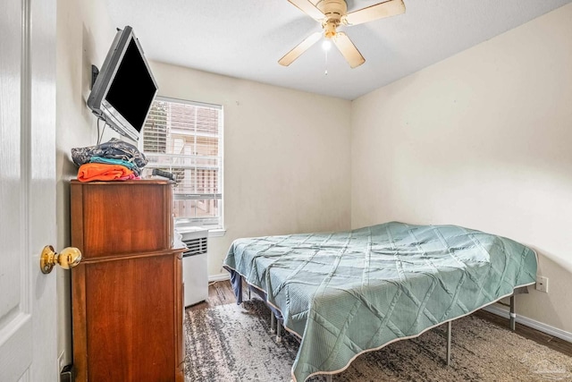 bedroom featuring wood-type flooring and ceiling fan