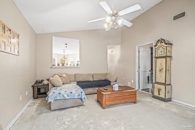 carpeted living room with ceiling fan and high vaulted ceiling