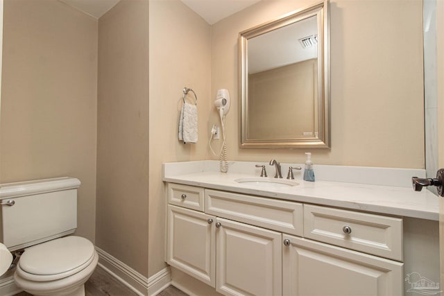 bathroom featuring hardwood / wood-style flooring, vanity, and toilet