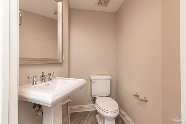 bathroom featuring sink, toilet, and hardwood / wood-style floors