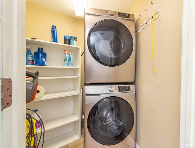 clothes washing area featuring stacked washer / drying machine