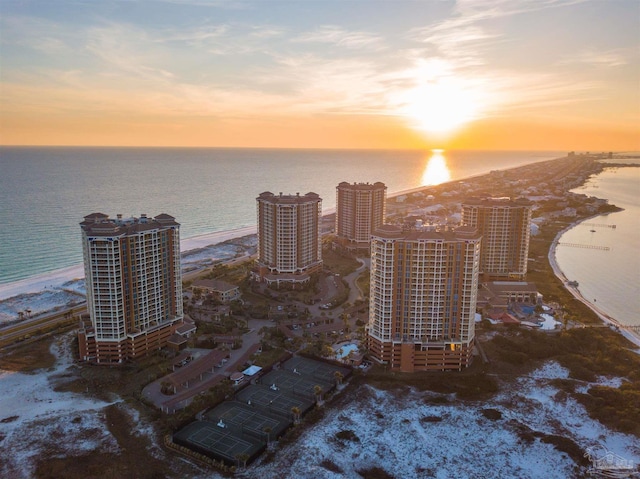 aerial view at dusk featuring a water view