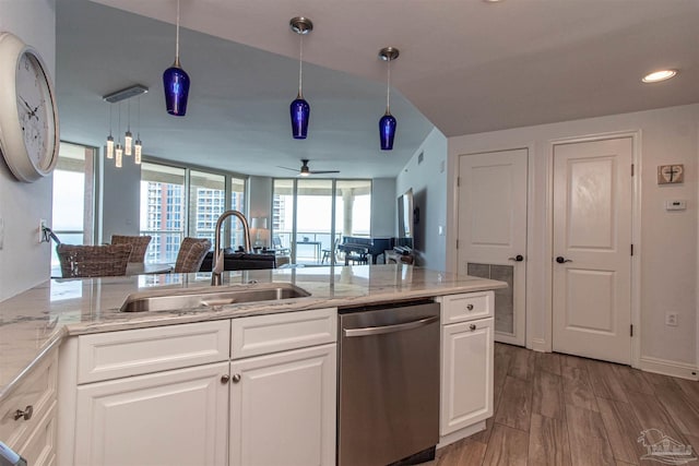 kitchen with a wealth of natural light, white cabinets, sink, and dishwasher