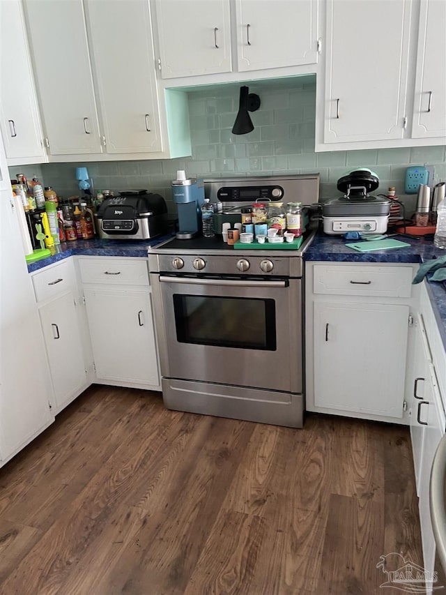 kitchen featuring white cabinetry, backsplash, stainless steel range, and dark hardwood / wood-style flooring