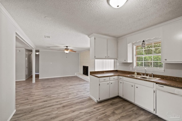 kitchen with light hardwood / wood-style flooring, crown molding, white cabinets, and dishwasher