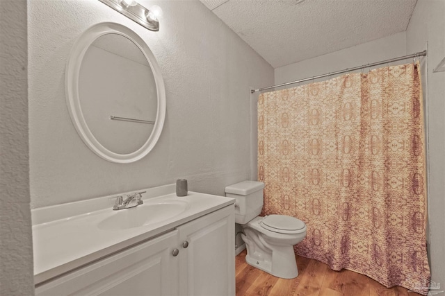 bathroom with vanity, toilet, a textured ceiling, hardwood / wood-style floors, and a shower with shower curtain