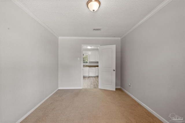 unfurnished room with ornamental molding, a textured ceiling, and light carpet