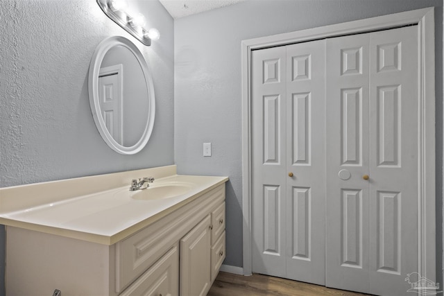 bathroom featuring wood-type flooring and vanity