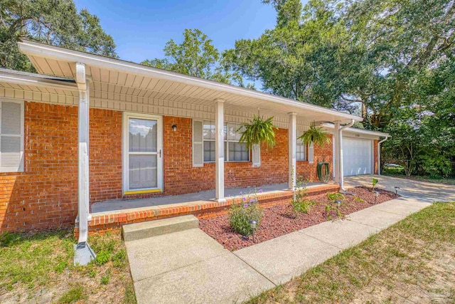 single story home with covered porch and a garage