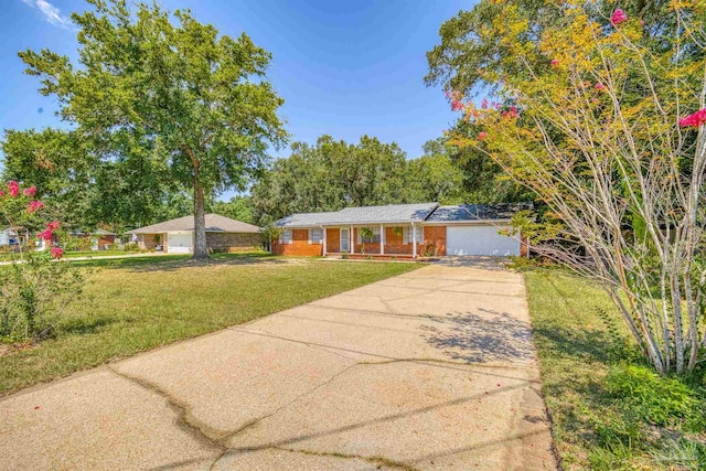 ranch-style home featuring a garage and a front yard