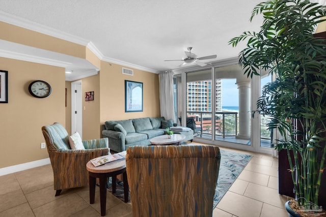 tiled living room featuring visible vents, ornamental molding, baseboards, and ceiling fan