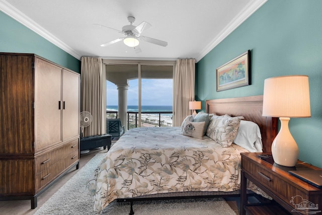 bedroom featuring ceiling fan, a water view, ornamental molding, and access to outside