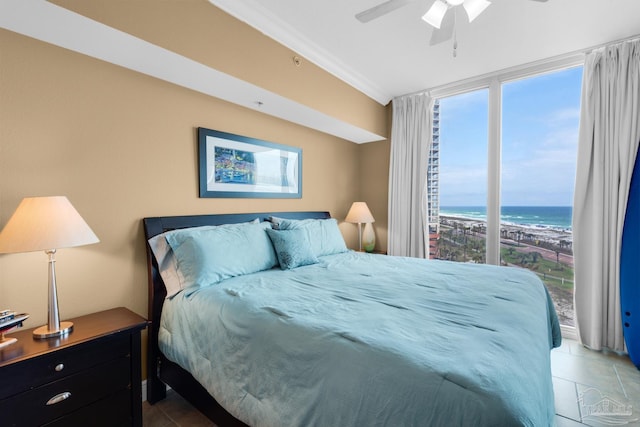 bedroom with a ceiling fan, ornamental molding, tile patterned floors, and a water view