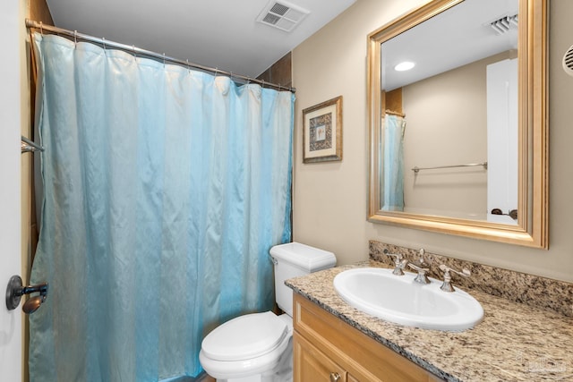 bathroom featuring toilet, a shower with curtain, vanity, and visible vents