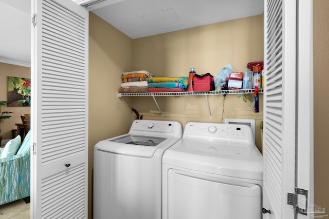 clothes washing area featuring separate washer and dryer and laundry area