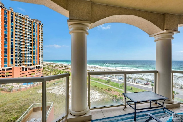 balcony with a view of the beach and a water view
