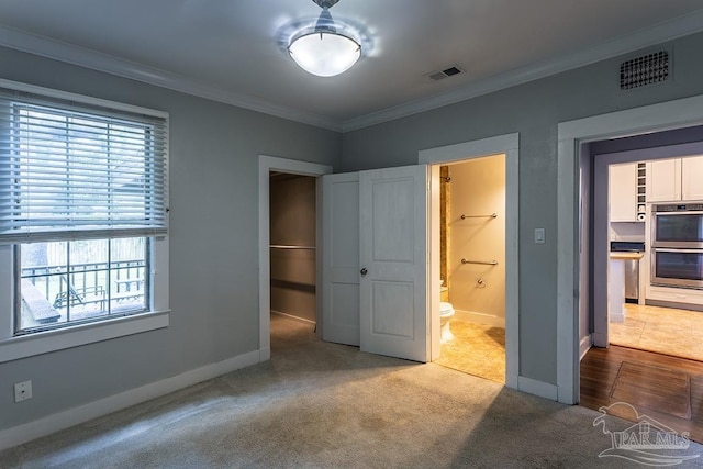 bedroom featuring baseboards, carpet floors, visible vents, and crown molding