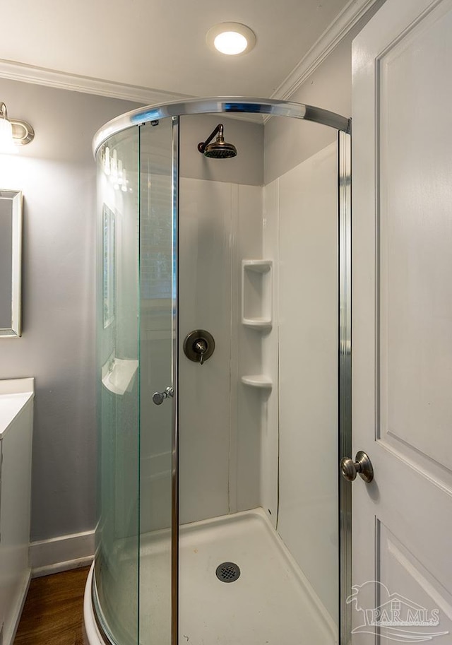 full bath with ornamental molding, a stall shower, and vanity