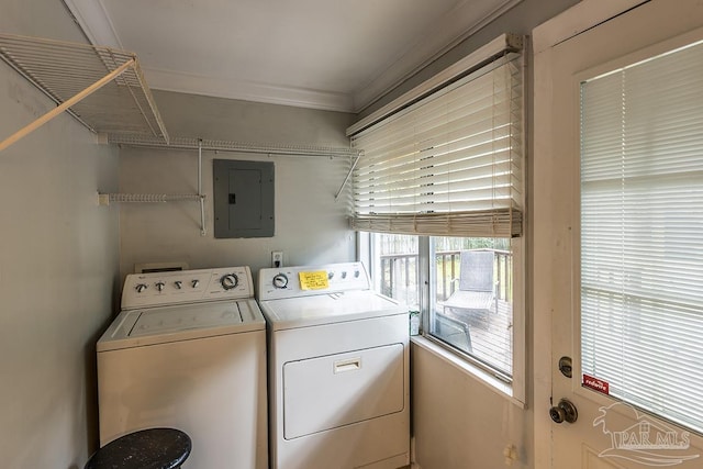 clothes washing area featuring laundry area, electric panel, ornamental molding, and washer and clothes dryer