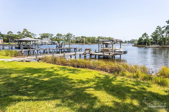 dock area with a lawn, a water view, and boat lift