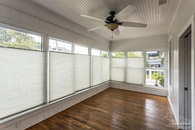 unfurnished sunroom featuring wood ceiling and a ceiling fan