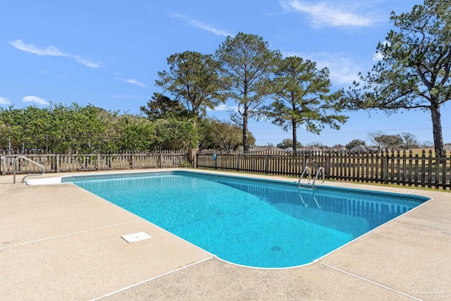 view of pool with a fenced in pool, a patio area, and fence