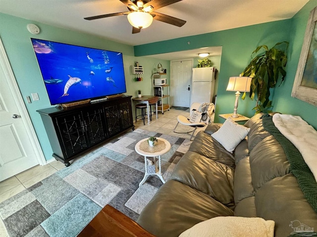 living area featuring tile patterned floors and ceiling fan