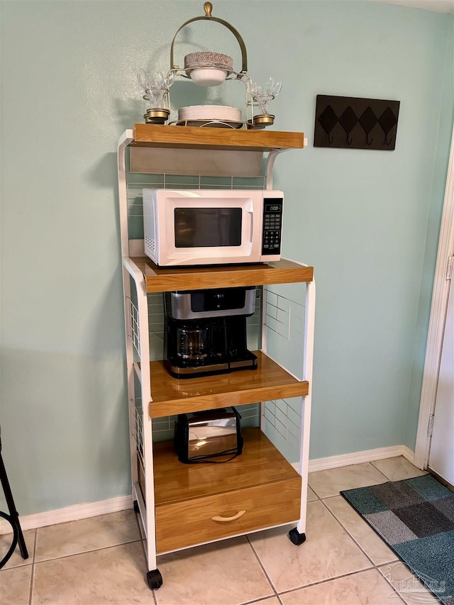 details featuring baseboards and white microwave