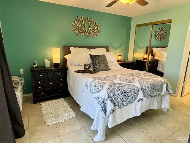 tiled bedroom with a closet and a ceiling fan