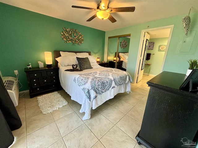 bedroom featuring a ceiling fan, a closet, and light tile patterned flooring
