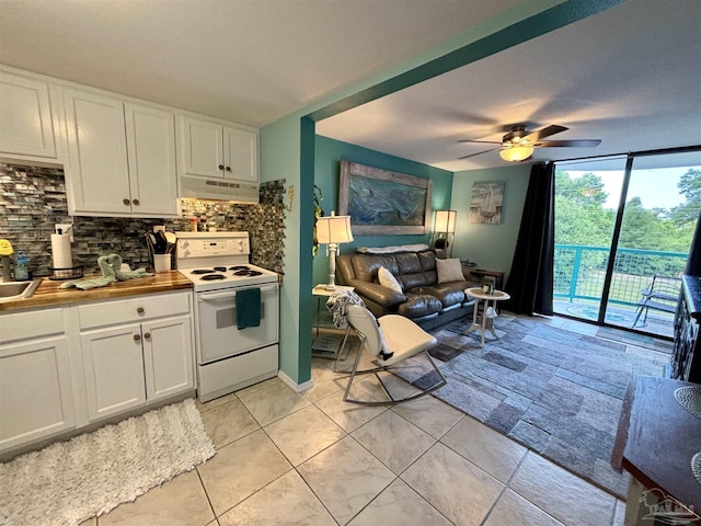 kitchen with decorative backsplash, under cabinet range hood, white range with electric stovetop, and ceiling fan