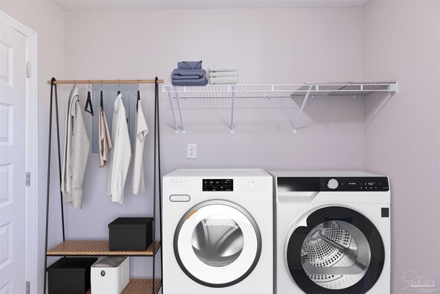 clothes washing area featuring separate washer and dryer