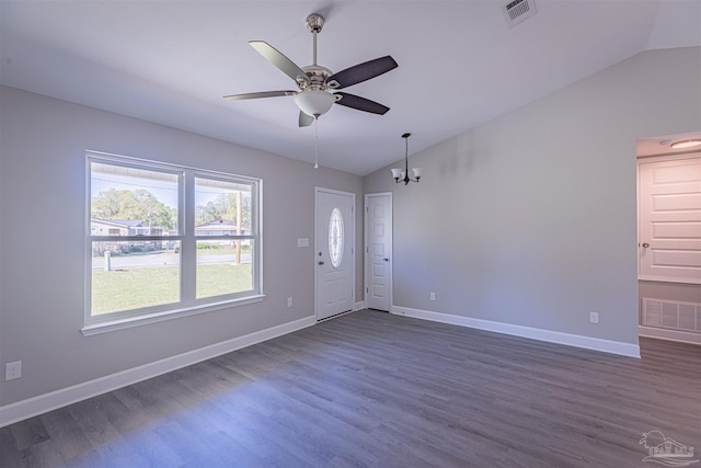 interior space with dark wood-type flooring, vaulted ceiling, and ceiling fan with notable chandelier