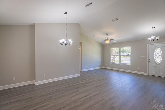 interior space featuring lofted ceiling, ceiling fan with notable chandelier, and dark hardwood / wood-style flooring