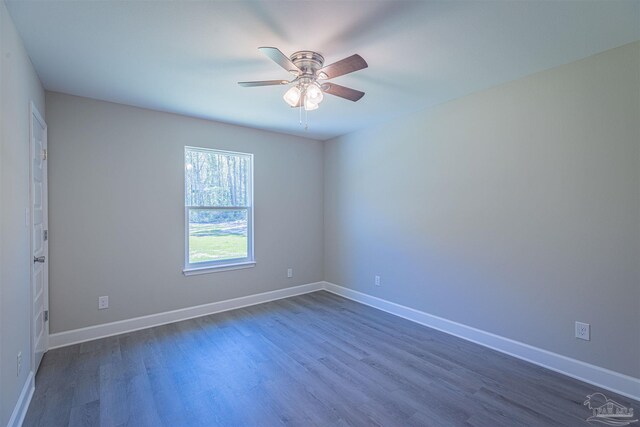 spare room featuring ceiling fan and dark hardwood / wood-style flooring