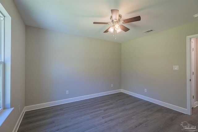 empty room with dark wood-type flooring and ceiling fan