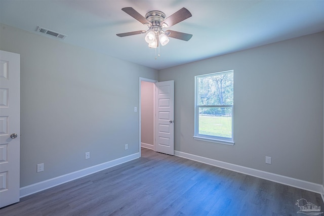 unfurnished room with ceiling fan and dark hardwood / wood-style flooring