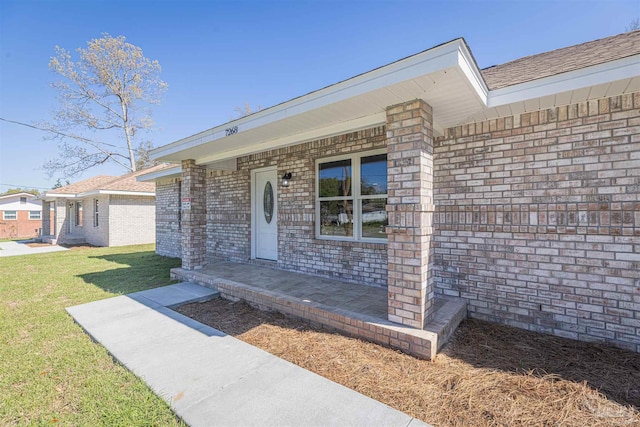 doorway to property featuring a yard