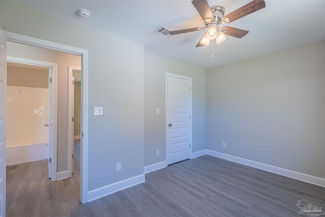 unfurnished bedroom with a closet, ceiling fan, and dark hardwood / wood-style flooring