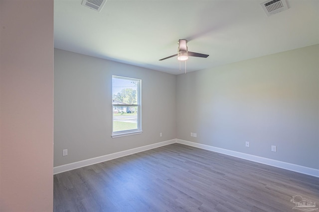 empty room featuring ceiling fan and dark hardwood / wood-style flooring