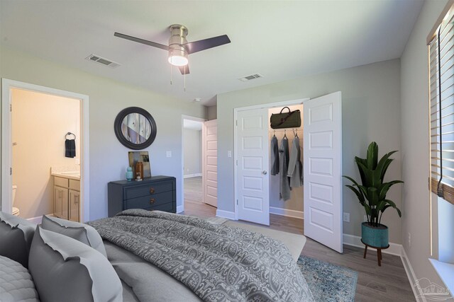 bedroom with ensuite bath, hardwood / wood-style flooring, a closet, and ceiling fan