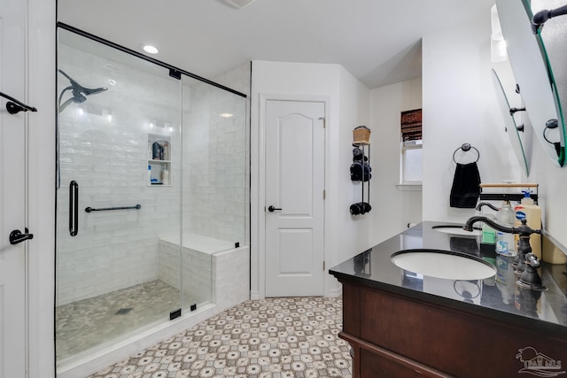 bathroom featuring an enclosed shower and vanity