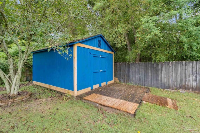 view of outbuilding with a lawn