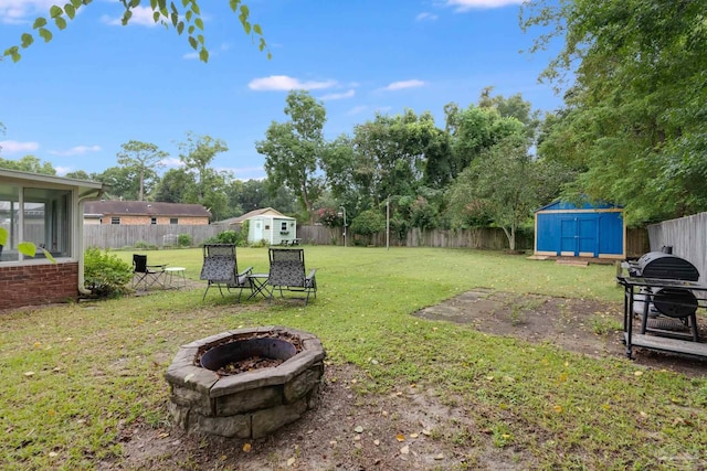 view of yard with a fire pit and a storage unit