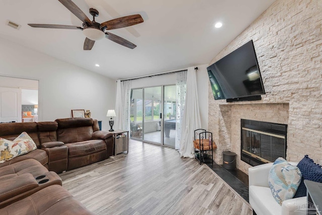 living room with a fireplace, light hardwood / wood-style flooring, and ceiling fan