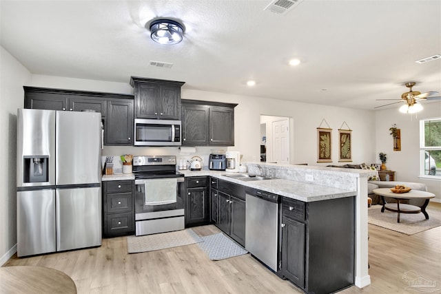 kitchen featuring appliances with stainless steel finishes, a sink, and visible vents