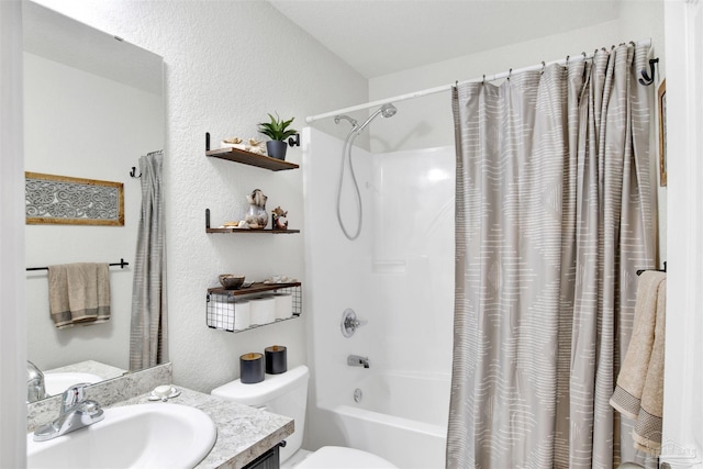 full bath with a textured wall, vanity, toilet, and shower / bath combo with shower curtain