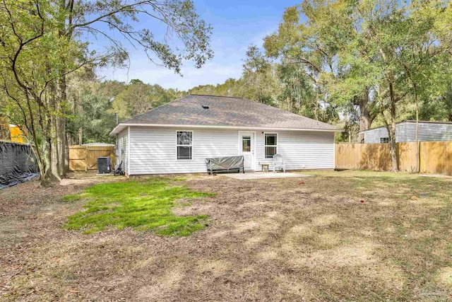 rear view of property with a patio area, a lawn, a fenced backyard, and central AC unit